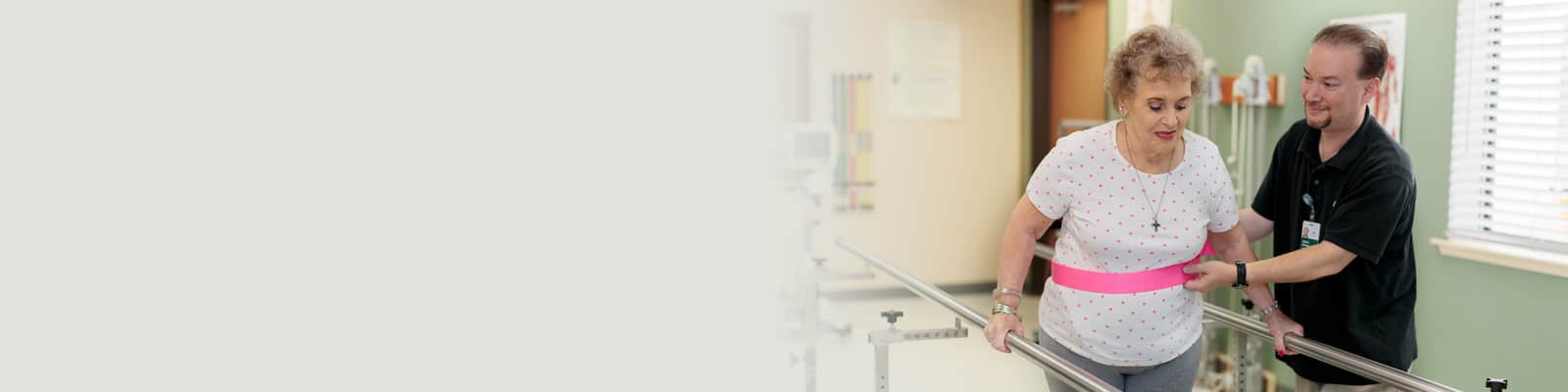 A physical therapist helping a woman walk