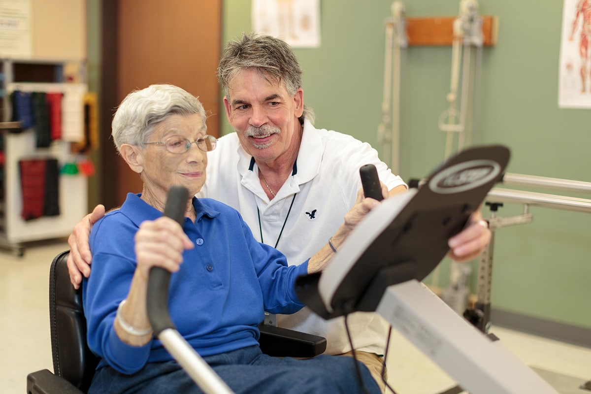 A therapist helping a woman do therapy at River Valley