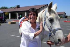 An elderly woman with a horse at River Valley